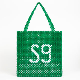 Front view of green Sweetgreen x Susan Alexandra beaded bag with "SG" in white beads.